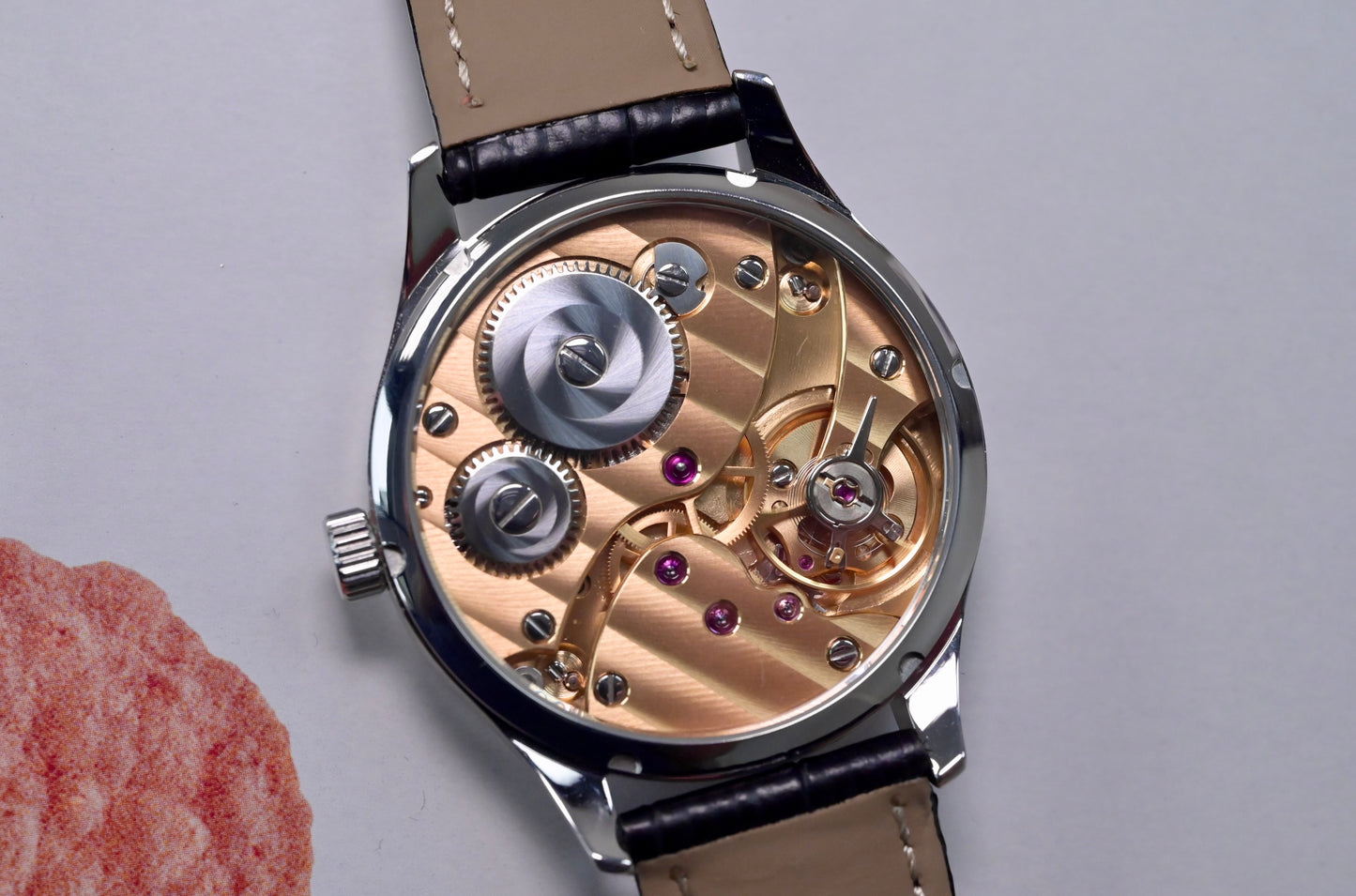 CHRYSOS  - Hand finished Swiss movement with gold movement and black MOP dial